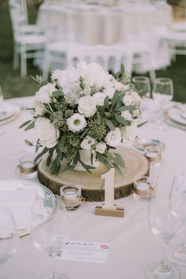 rustic white roses and seeded eucalyptus tree stump wedding centerpiece