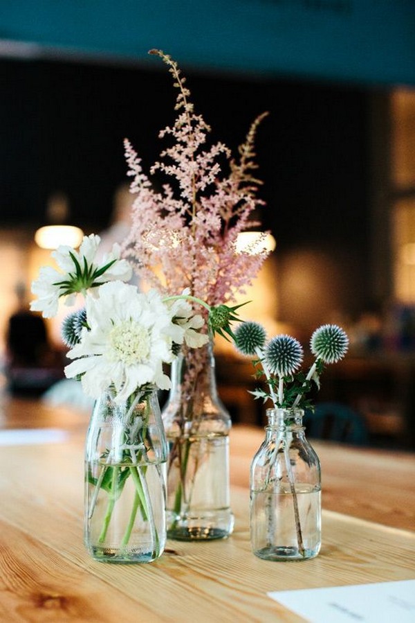 simple mixed bottles and wildflowers wedding centerpiece