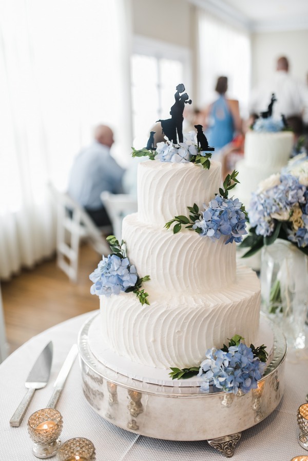 white buttercream wedding cake with light blue hydrangeas