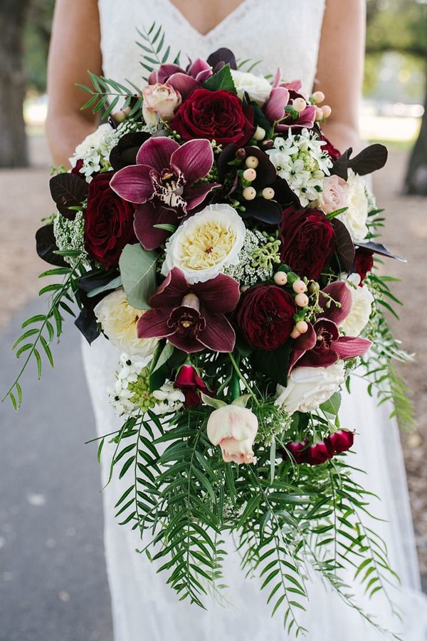 Cascading burgundy orchid and rose wedding bouquet