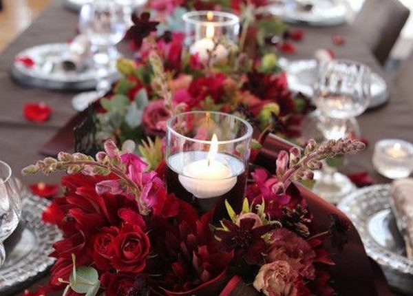 burgundy flowers around candles wedding centerpiece