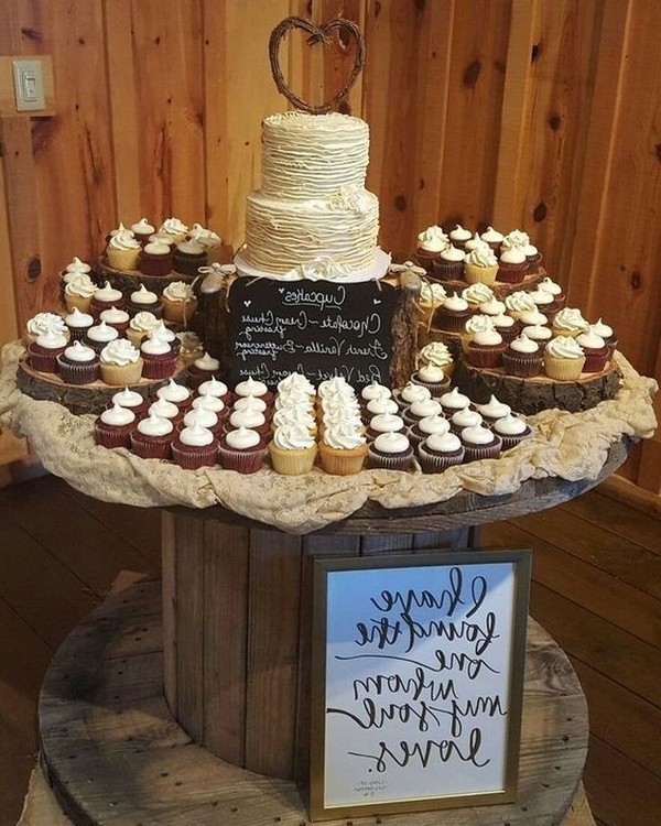 country wedding cake with cupcakes around