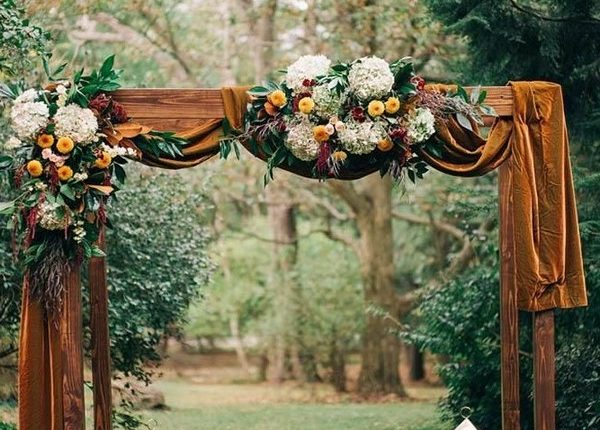 rustic outdoor fall wedding arches and backdrop 1