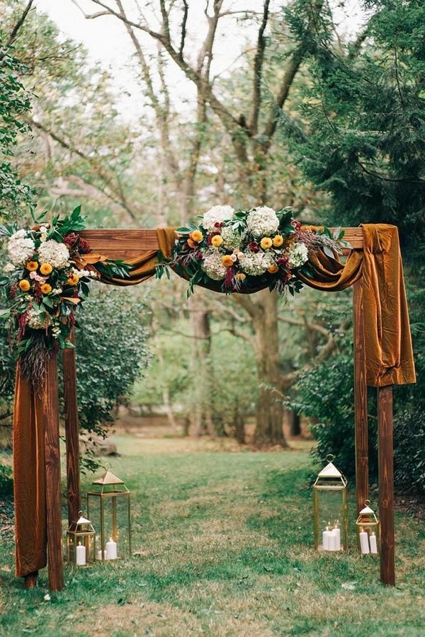 rustic outdoor fall wedding arches and backdrop