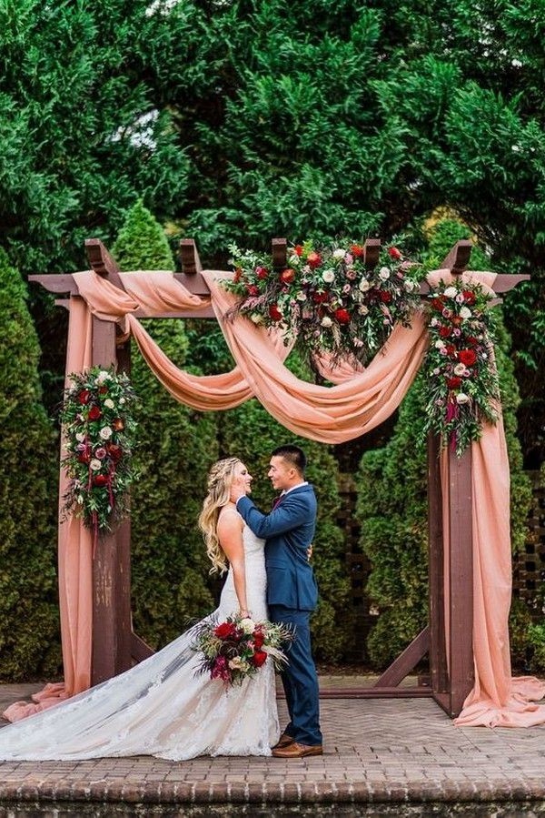 rustic outdoor fall wedding arches and backdrop