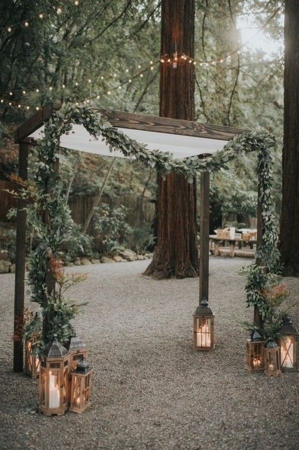 rustic outdoor fall wedding arches and backdrop