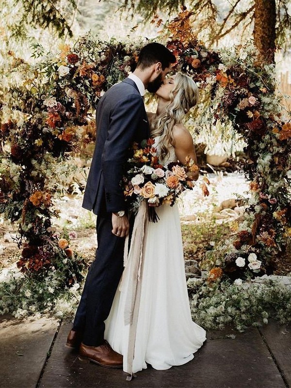 rustic outdoor fall wedding arches and backdrop