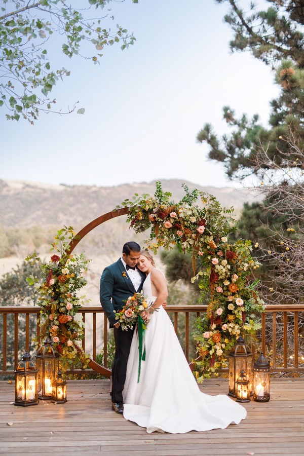 rustic outdoor fall wedding arches and backdrop