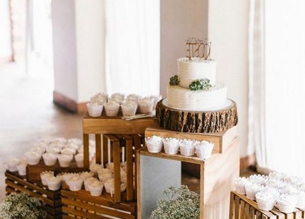 rustic wedding cake display with cupcakes
