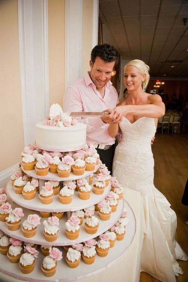 simple wedding cake with pink cupcakes