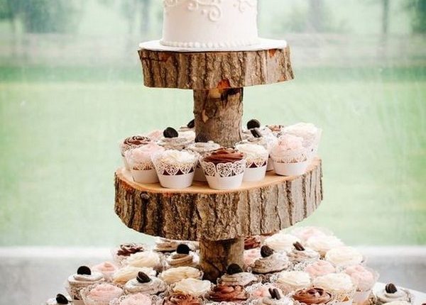 vintage country wedding cake display with cupcakes