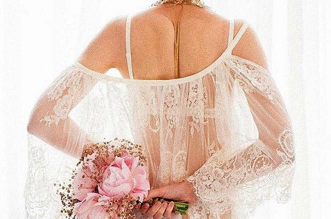 wedding boudoir book bride with updo in white lace holds a rose bouquet bridalboudoir via instagram
