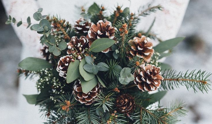 pine cone and greenery winter wedding bouquets