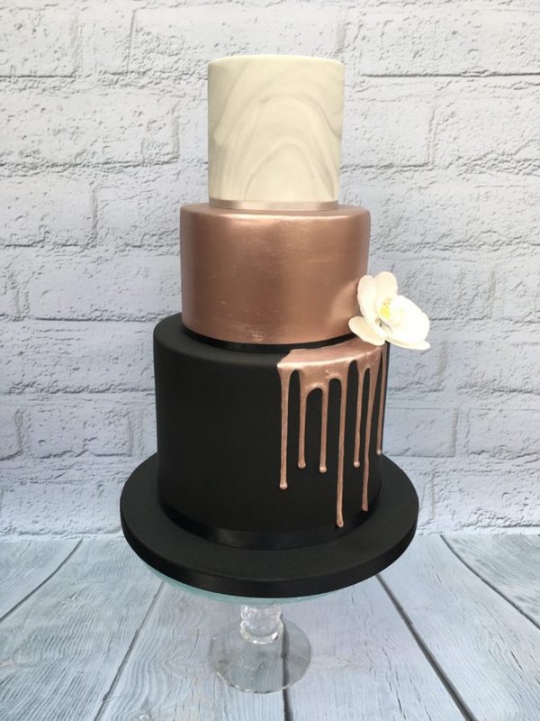 rose gold dripped and black wedding cake