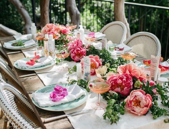 garden bridal shower ideas simple tablescape with a greenery and peony table runner blooms on each setting and neutral textiles