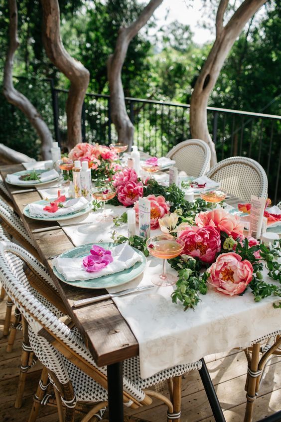 garden bridal shower ideas simple tablescape with a greenery and peony table runner blooms on each setting and neutral textiles