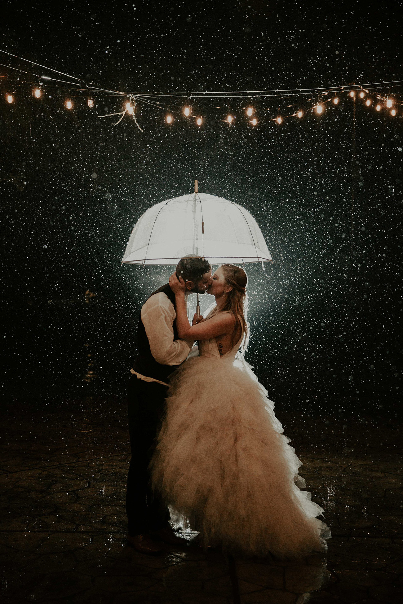 bride groom rain on wedding day umbrella