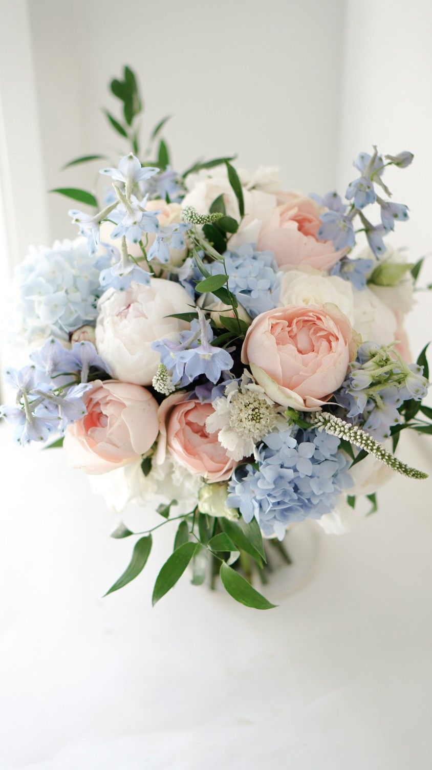 peach roses light blue hydrangea wedding bouquet